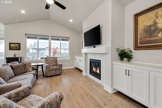 1332 SE 14th Ave, Canby, OR 97013 - living area featuring a tiled fireplace, ceiling fan, lofted ceiling, light wood-style floors, and baseboards
