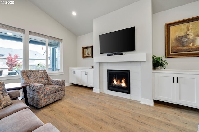 1332 SE 14th Ave, Canby, OR 97013 - living room with a tile fireplace, vaulted ceiling, light wood-style flooring, recessed lighting, and baseboards