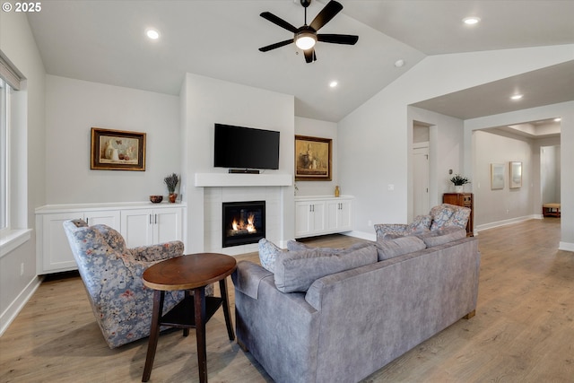 1332 SE 14th Ave, Canby, OR 97013 - living area featuring a ceiling fan, light wood-style floors, lofted ceiling, a tiled fireplace, and baseboards