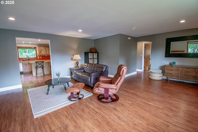 living room featuring wood finished floors, recessed lighting, and baseboards