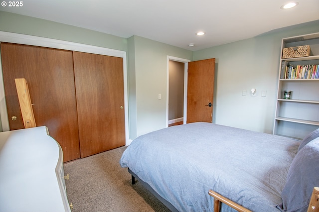 bedroom with carpet flooring, recessed lighting, and a closet