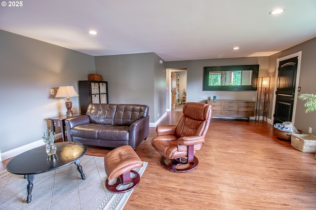 living room featuring wood finished floors, baseboards, and recessed lighting