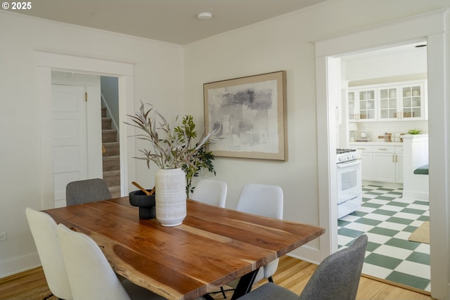 2814 NE 34th Ave, Portland, OR 97212 - dining area featuring stairs, light floors, and crown molding