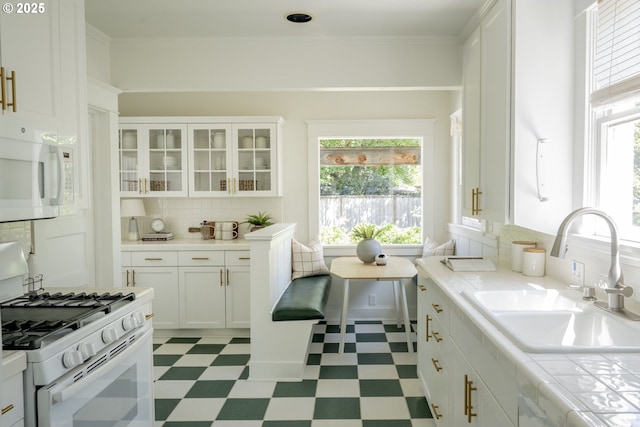 2814 NE 34th Ave, Portland, OR 97212 - kitchen featuring white appliances, a sink, light flooring, healthy amount of natural light, and ornamental molding