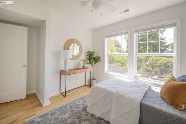 2814 NE 34th Ave, Portland, OR 97212 - bedroom featuring multiple windows, wood finished floors, baseboards, and a ceiling fan