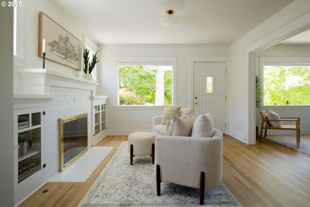 2814 NE 34th Ave, Portland, OR 97212 - living room with light wood-type flooring, baseboards, and a fireplace