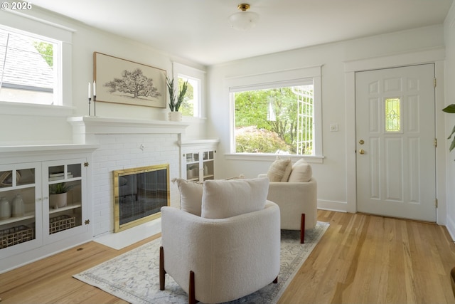 2814 NE 34th Ave, Portland, OR 97212 - living area with healthy amount of natural light, light wood-style flooring, and a brick fireplace