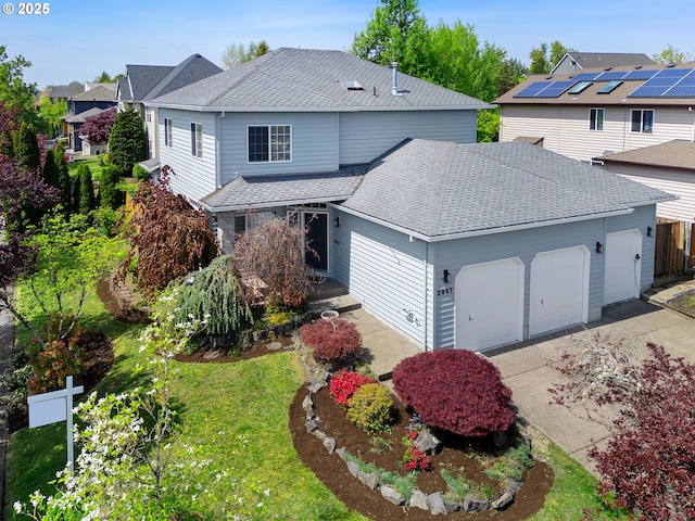 traditional-style house featuring fence, roof with shingles, a residential view, a garage, and driveway