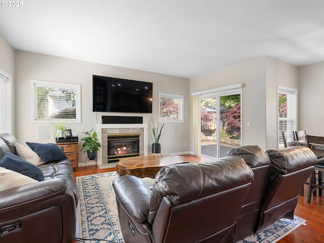 living room featuring a high end fireplace and wood finished floors
