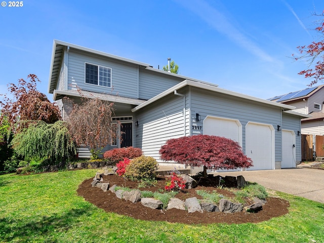 traditional home featuring an attached garage, concrete driveway, and a front yard