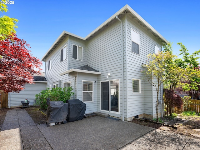 back of property featuring a patio, fence, and roof with shingles