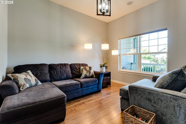 4675 Symphony Dr, Eugene, OR 97404 - living area featuring light wood-type flooring, healthy amount of natural light, and a chandelier