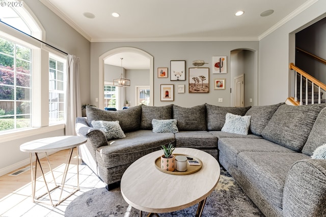 4675 Symphony Dr, Eugene, OR 97404 - living area featuring arched walkways, wood finished floors, ornamental molding, healthy amount of natural light, and recessed lighting