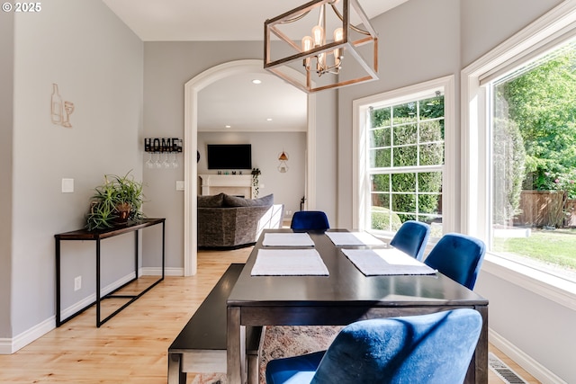 4675 Symphony Dr, Eugene, OR 97404 - dining space featuring light wood-type flooring, a chandelier, arched walkways, and recessed lighting