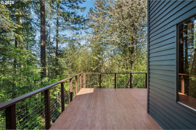 wooden deck featuring a wooded view