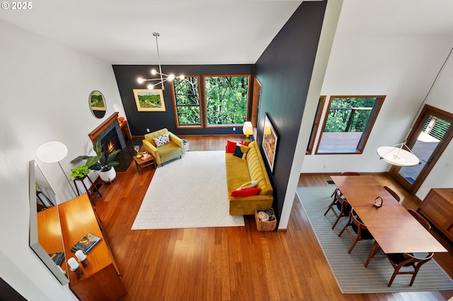 rec room featuring plenty of natural light, wood finished floors, and a chandelier