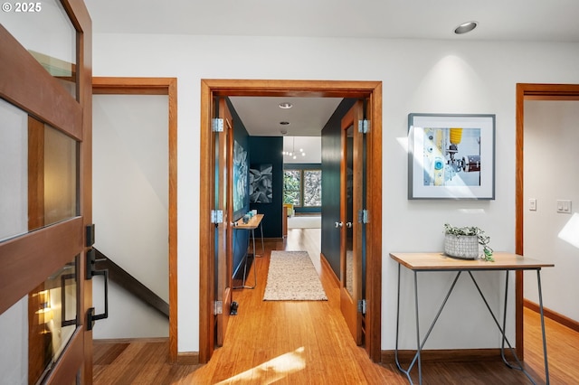 hallway with baseboards, recessed lighting, and wood finished floors