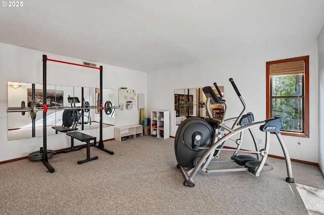 workout area with baseboards and carpet flooring