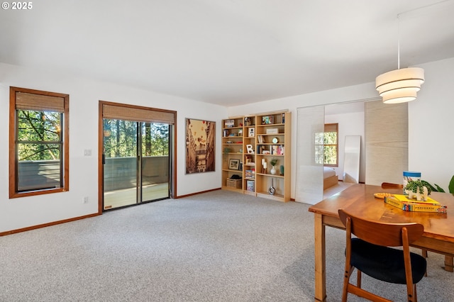 dining space with baseboards, carpet, and a wealth of natural light