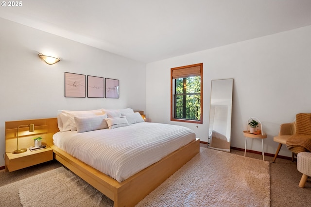 carpeted bedroom featuring baseboards