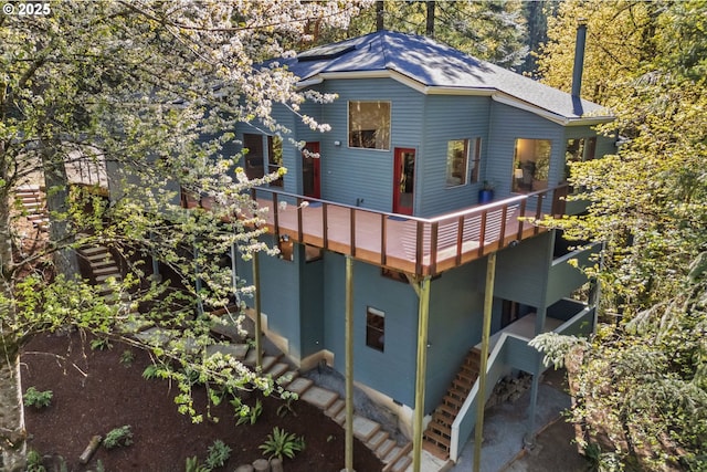 view of front facade featuring stairway and a deck