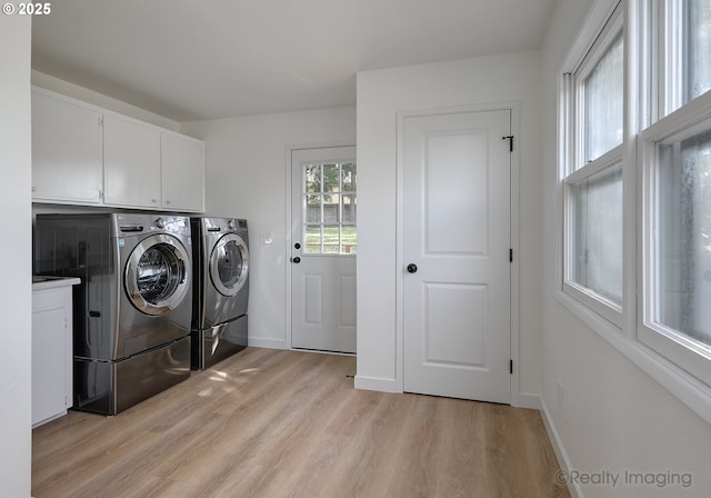 laundry area featuring cabinet space, baseboards, light wood finished floors, and independent washer and dryer