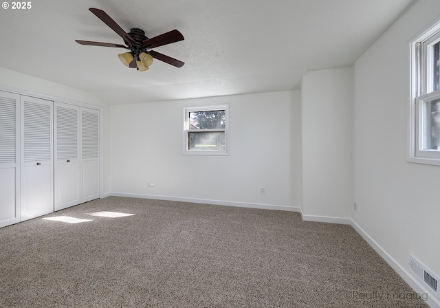 unfurnished bedroom featuring visible vents, baseboards, a ceiling fan, carpet, and a closet