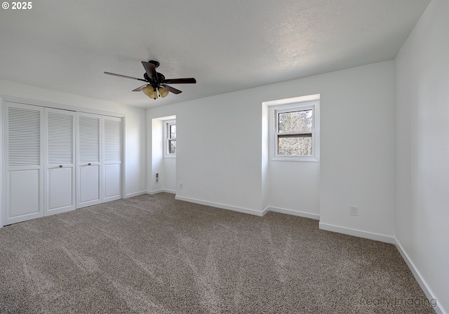 unfurnished bedroom with carpet, multiple windows, and baseboards