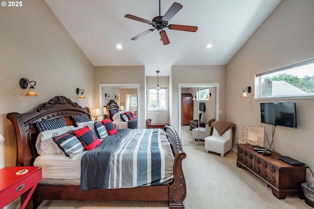 bedroom with ceiling fan, light colored carpet, and vaulted ceiling