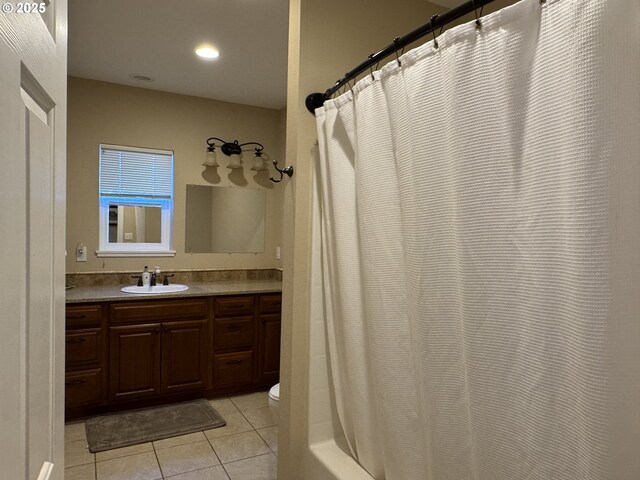 bathroom featuring vanity, tile patterned floors, and toilet