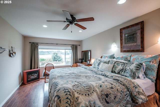 bedroom with dark hardwood / wood-style floors and ceiling fan