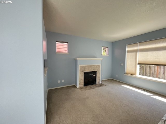 6230 SW Zabaco Ter, Beaverton, OR 97078 - unfurnished living room featuring carpet, a tile fireplace, and baseboards