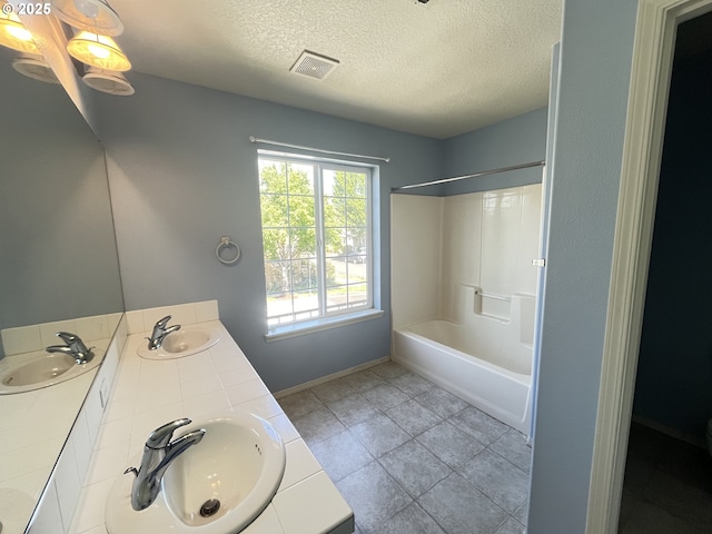 6230 SW Zabaco Ter, Beaverton, OR 97078 - bathroom featuring a textured ceiling, double vanity, baseboards, bathing tub / shower combination, and tile patterned floors