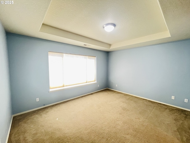 6230 SW Zabaco Ter, Beaverton, OR 97078 - carpeted empty room featuring a tray ceiling, baseboards, and a textured ceiling