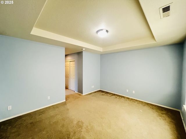 6230 SW Zabaco Ter, Beaverton, OR 97078 - spare room featuring a tray ceiling, carpet, and baseboards