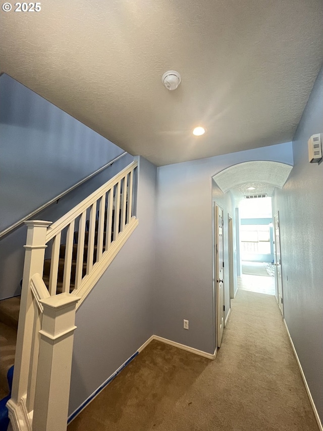 6230 SW Zabaco Ter, Beaverton, OR 97078 - hall featuring arched walkways, baseboards, carpet, stairs, and recessed lighting