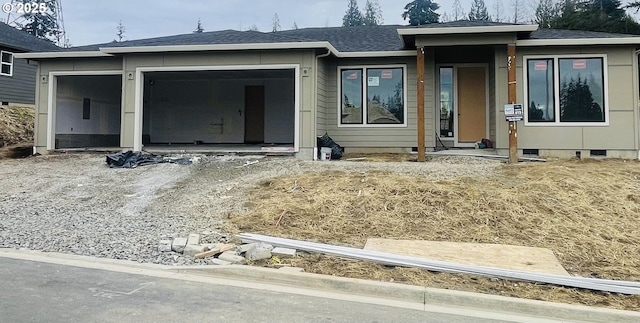 view of front of house with crawl space, a garage, and driveway