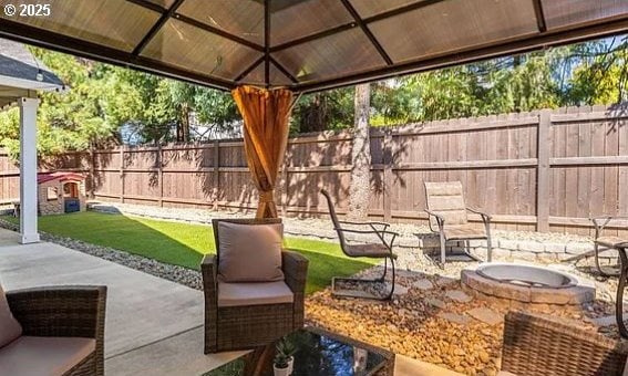 view of patio featuring a gazebo, an outdoor fire pit, and a fenced backyard