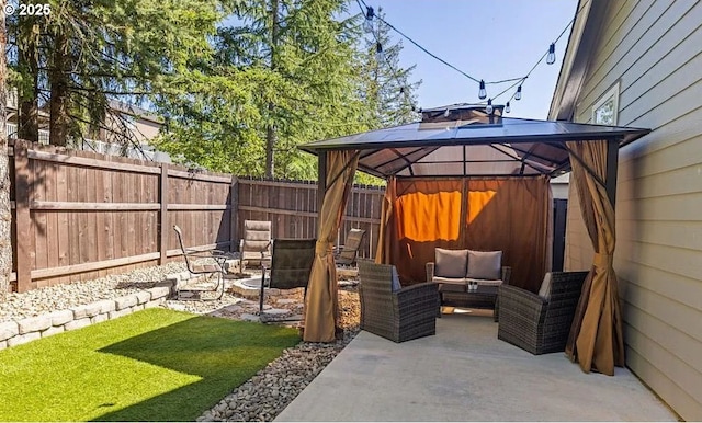 view of patio / terrace featuring a gazebo, a fenced backyard, and an outdoor living space with a fire pit