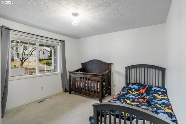 carpeted bedroom with a textured ceiling