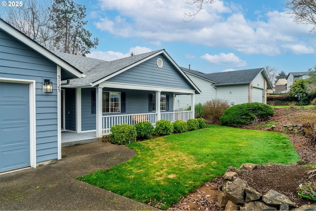 view of front of house featuring a porch, a front lawn, and a garage