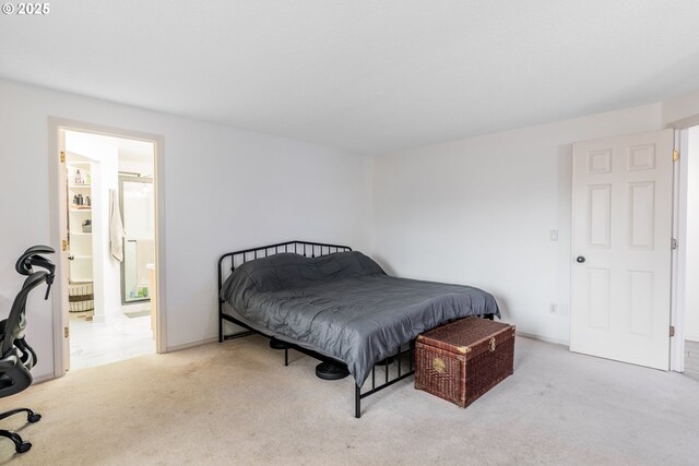 carpeted bedroom featuring ensuite bath