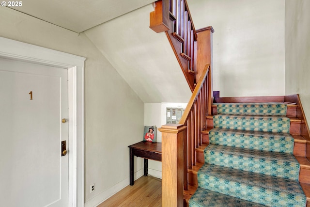 2066 NW Overton St, Portland, OR 97209 - staircase featuring wood finished floors and lofted ceiling