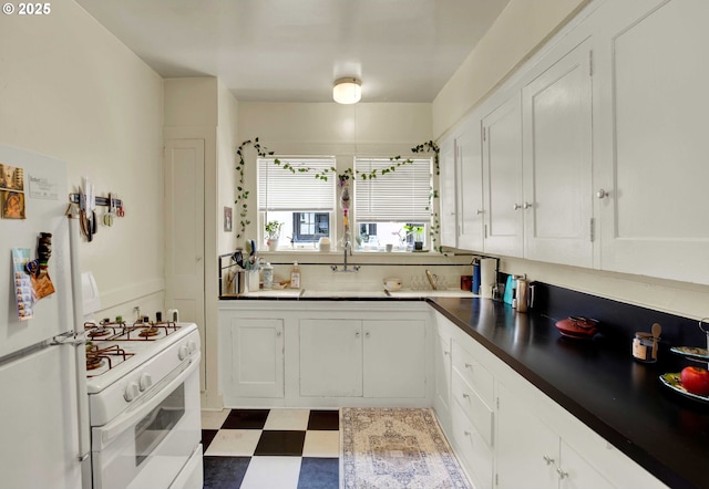 2066 NW Overton St, Portland, OR 97209 - kitchen featuring white appliances, white cabinets, and tile patterned floors