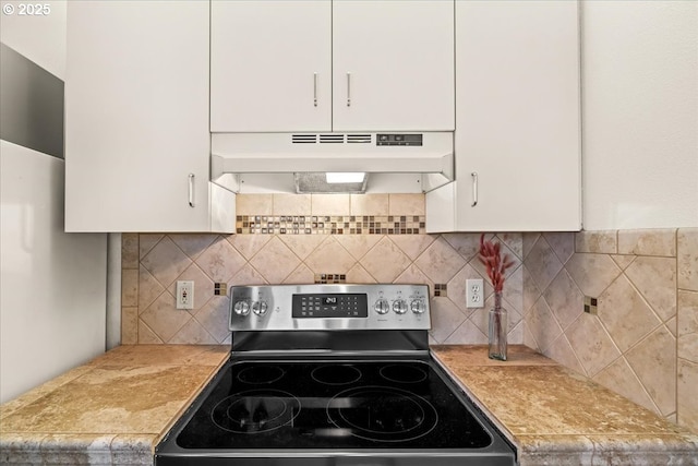 413 NW Uptown Ter Unit 2A, Portland, OR 97210 - kitchen featuring stainless steel electric stove, under cabinet range hood, white cabinets, and light countertops