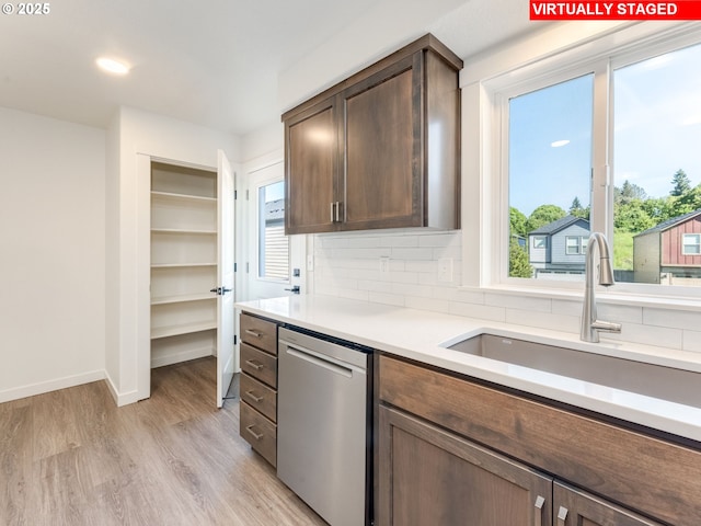 4578 NE Nicholson Loop, Vancouver, WA 98661 - kitchen featuring dishwasher, a sink, decorative backsplash, and light countertops