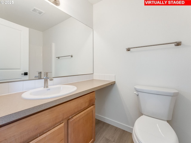 4578 NE Nicholson Loop, Vancouver, WA 98661 - bathroom featuring wood finished floors, toilet, baseboards, and vanity