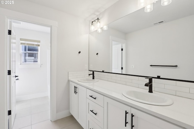 18315 SW Silvertip St, Beaverton, OR 97007 - bathroom featuring double vanity, tile patterned flooring, and baseboards
