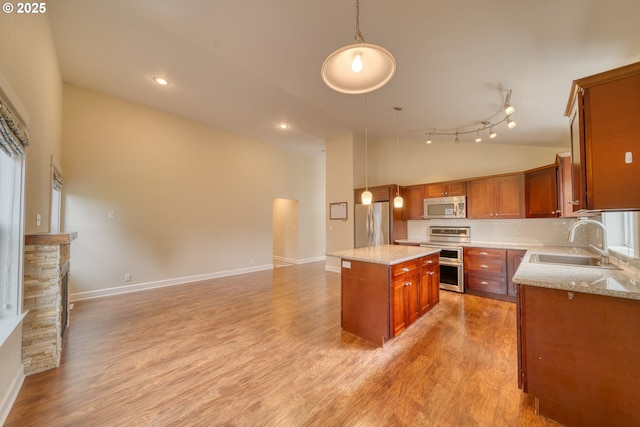 2639 Sykes Rd, Saint Helens, OR 97051 - kitchen featuring stainless steel appliances, a sink, a kitchen island, backsplash, and decorative light fixtures