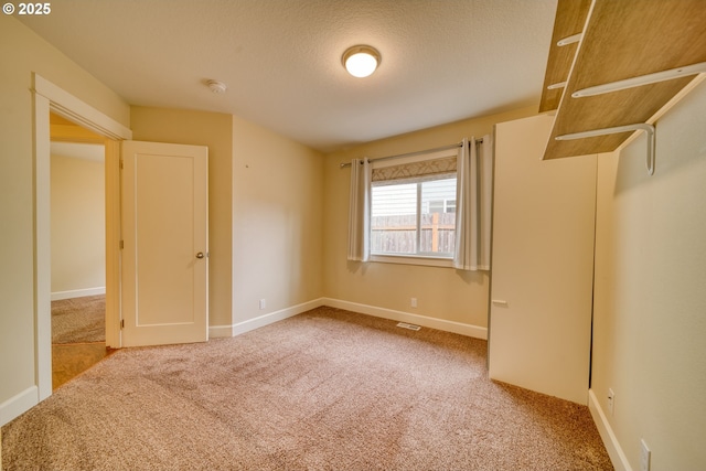 2639 Sykes Rd, Saint Helens, OR 97051 - unfurnished bedroom featuring carpet floors, baseboards, and a textured ceiling